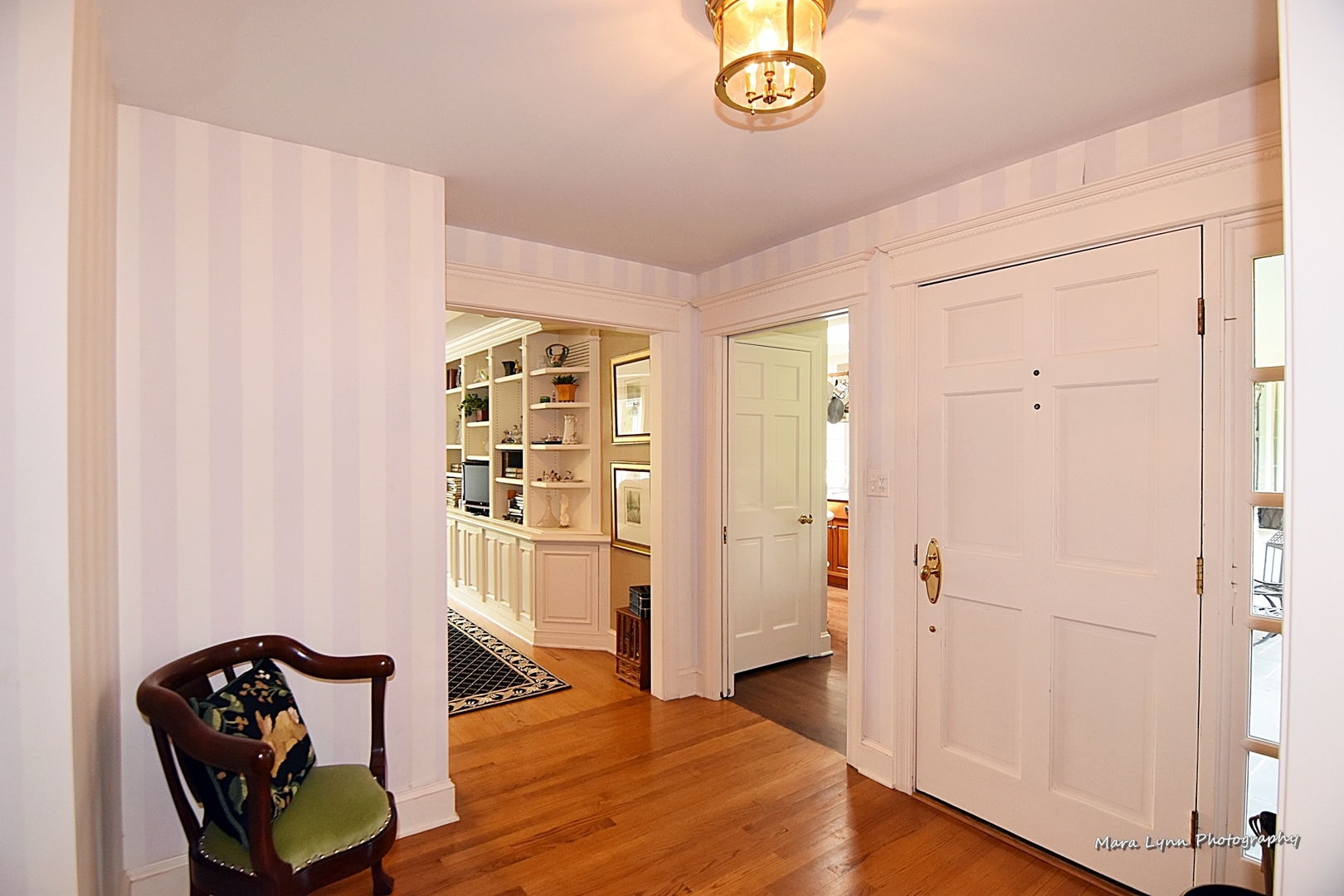 33W981 Army Trail Road Wayne, IL 60184 - Photo 4 of 71 a view of a hallway with wooden floor and a cabinet