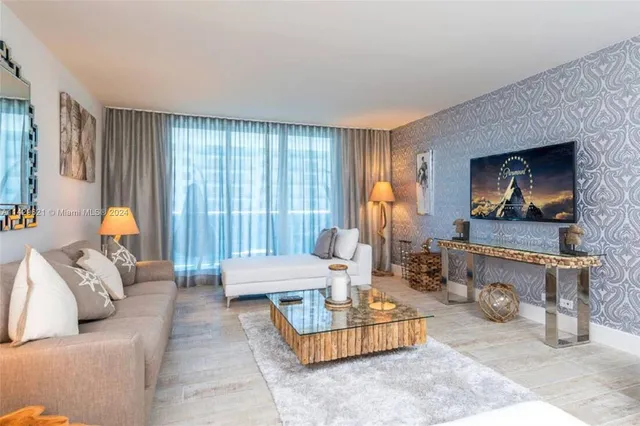 a kitchen with a stove a microwave and white cabinets