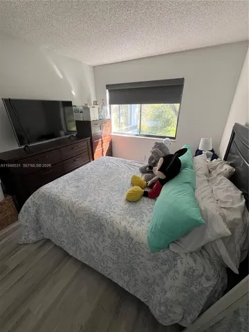 a bedroom with a bed and flat screen tv