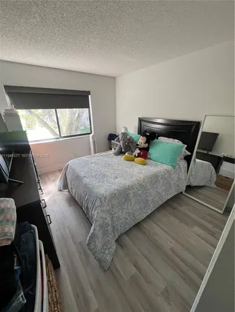 a bedroom with bed and window