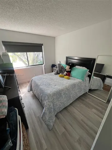 a bedroom with bed and window