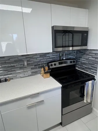 a kitchen with a stove and a microwave