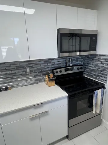 a kitchen with a stove and a microwave