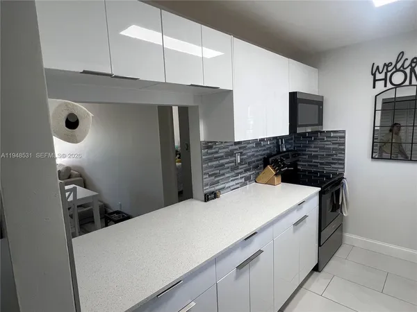 a kitchen with a stove and a refrigerator