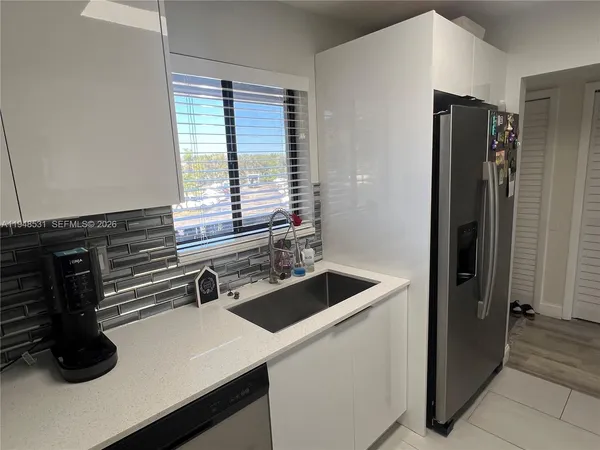 a kitchen with a sink and a refrigerator