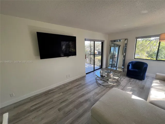 a living room with furniture window and flat screen tv