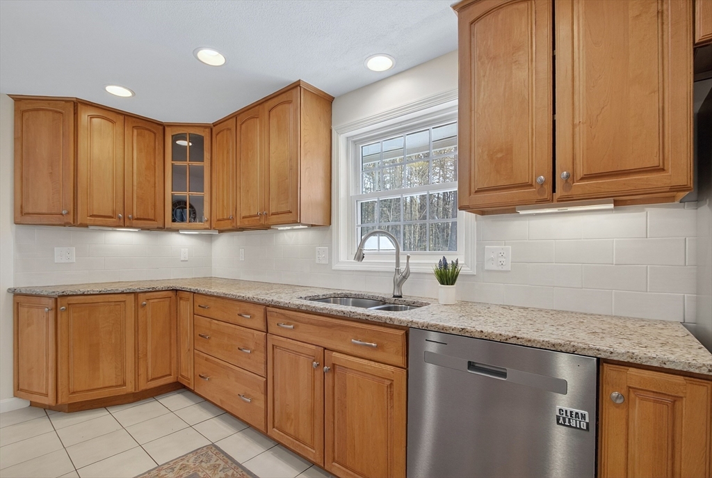 11 Smoke Rise Drive Chelmsford, MA 01824 - Photo 16 of 28 a kitchen with stainless steel appliances granite countertop a sink a stove cabinets and granite counter top