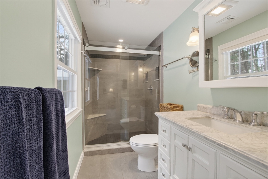11 Smoke Rise Drive Chelmsford, MA 01824 - Photo 20 of 28 a bathroom with a granite countertop sink toilet and shower