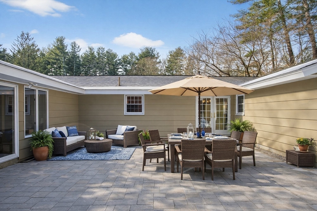 11 Smoke Rise Drive Chelmsford, MA 01824 - Photo 25 of 28 a view of a patio with table and chairs under an umbrella