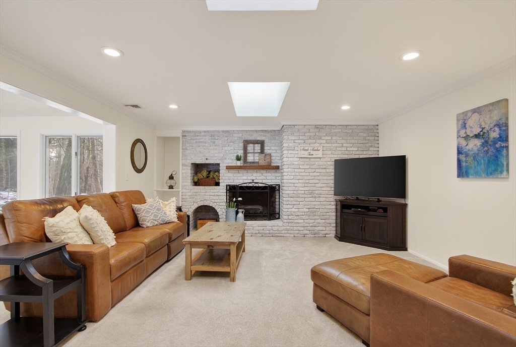 11 Smoke Rise Drive Chelmsford, MA 01824 - Photo 7 of 28 a living room with furniture a flat screen tv and a fireplace