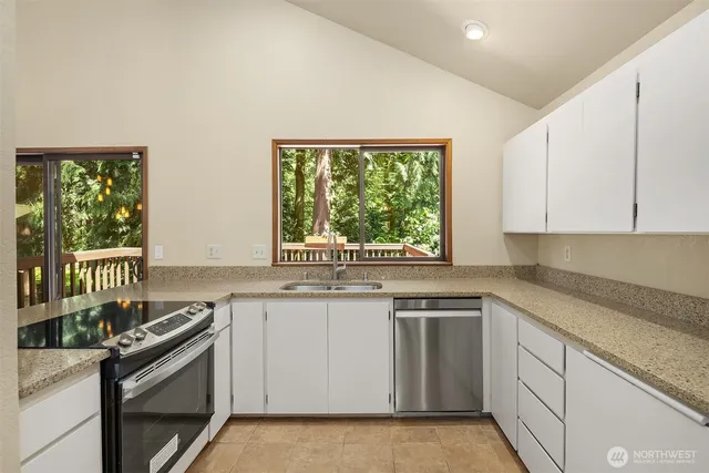 a kitchen with a sink stove and cabinets