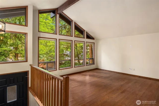 an empty room with large windows