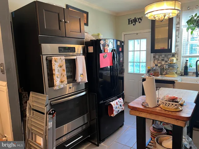 a living room with furniture a fireplace and a chandelier