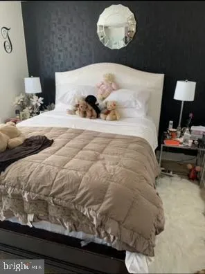 a bedroom with a bed and dresser