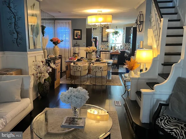 a living room with furniture and a chandelier