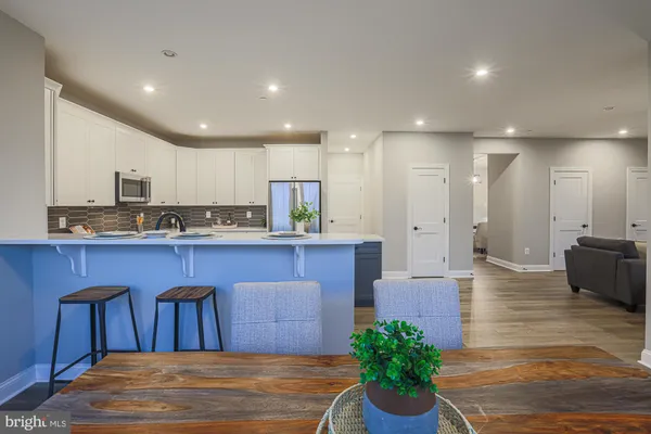 a living room with furniture a rug and a wooden floor
