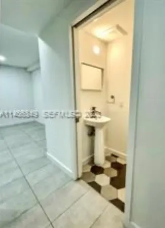 a bathroom with a sink toilet and mirror