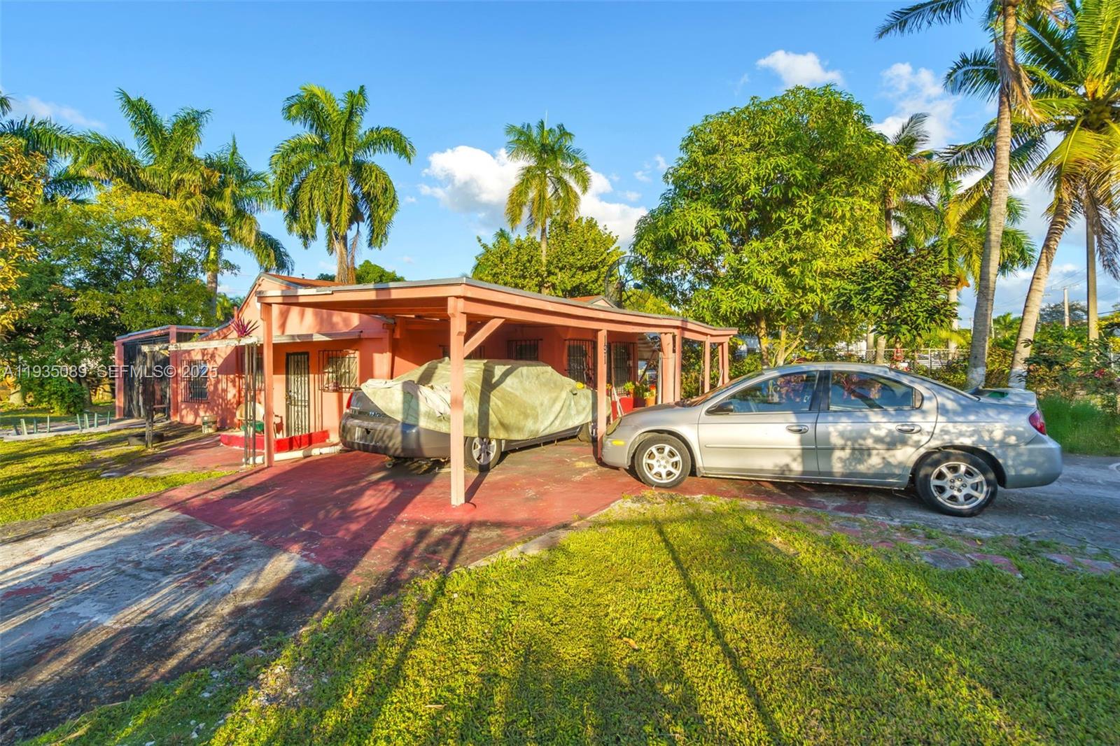 191 Northwest 83rd Street Miami, FL 33150 - Photo 2 of 35 a view of a yard with table and chairs under an umbrella