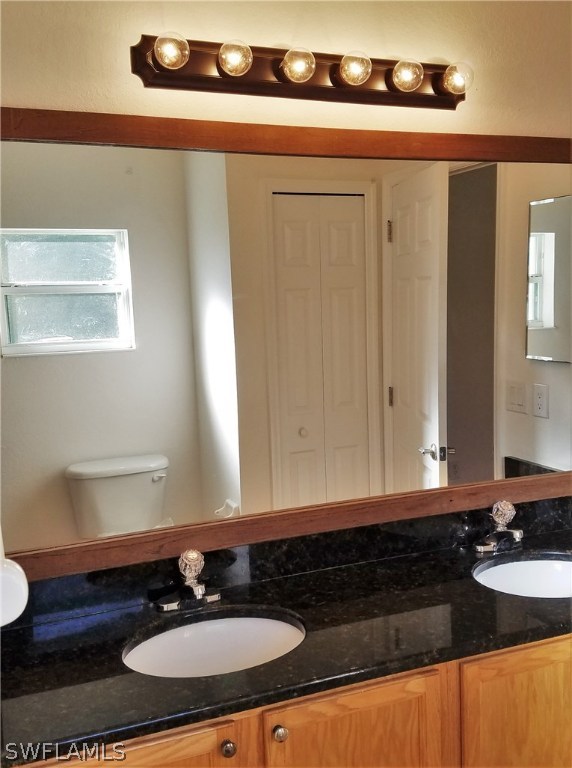 2910 25th Street West Lehigh Acres, FL 33971 - Photo 11 of 15 a bathroom with a sink and a mirror