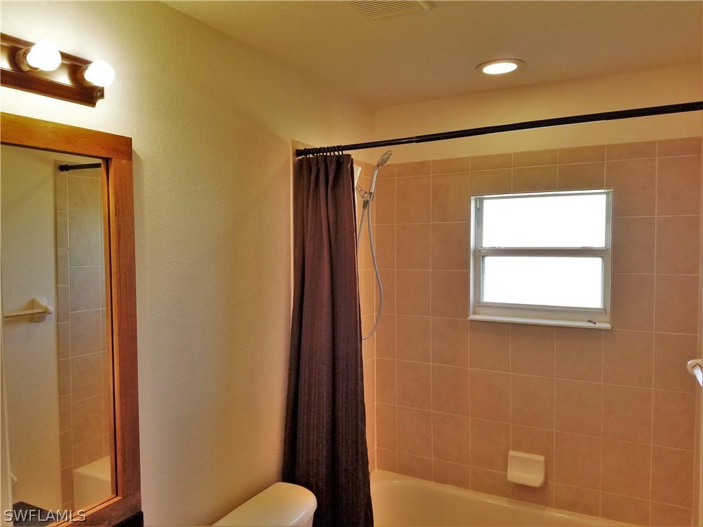 2910 25th Street West Lehigh Acres, FL 33971 - Photo 5 of 15 a bathroom with a shower and a toilet