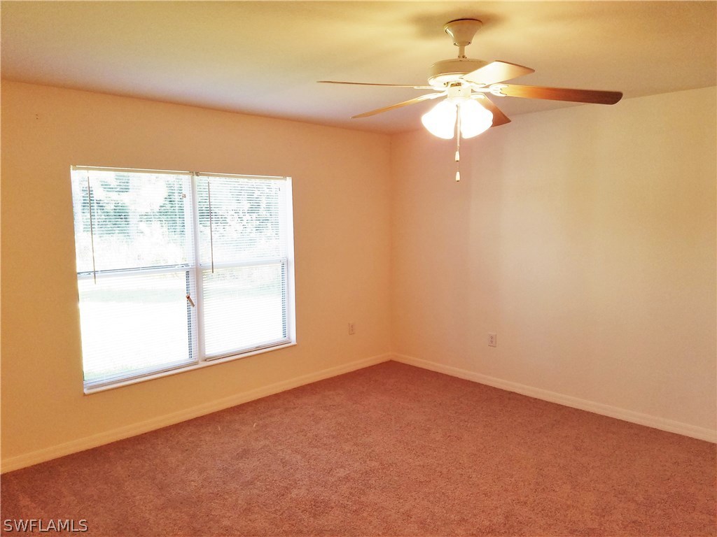 2910 25th Street West Lehigh Acres, FL 33971 - Photo 7 of 15 an empty room with a window