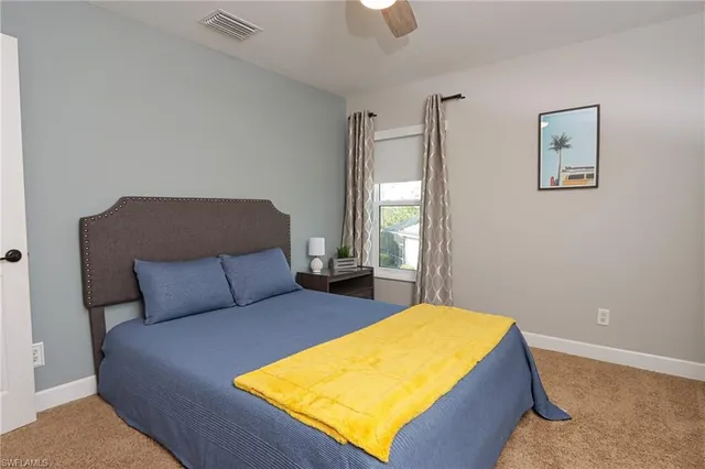 a bedroom with a bed and window