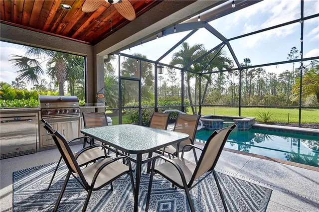 a view of a patio with a table chairs and a backyard