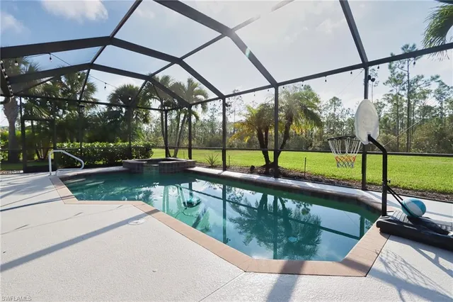 a view of a swimming pool with a bench and floor to ceiling window