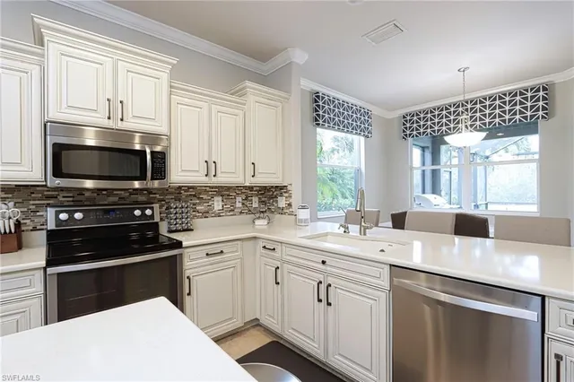 a kitchen with a sink stove and microwave