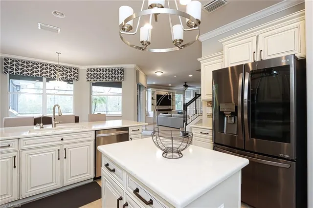 a kitchen with a sink a counter space cabinets and stainless steel appliances