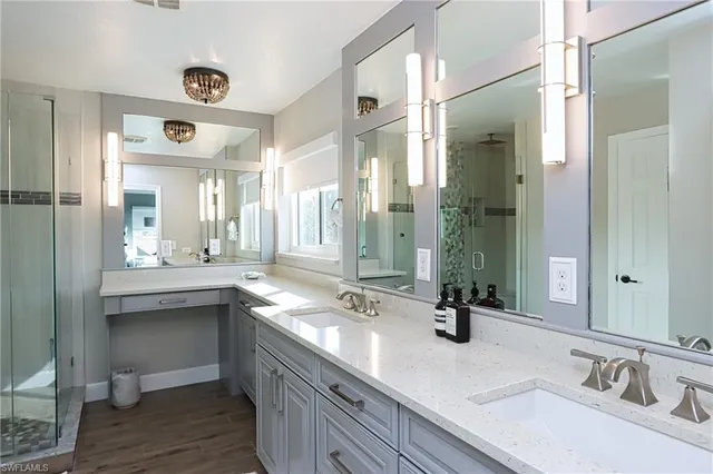 a bathroom with double vanity sinks and a mirror