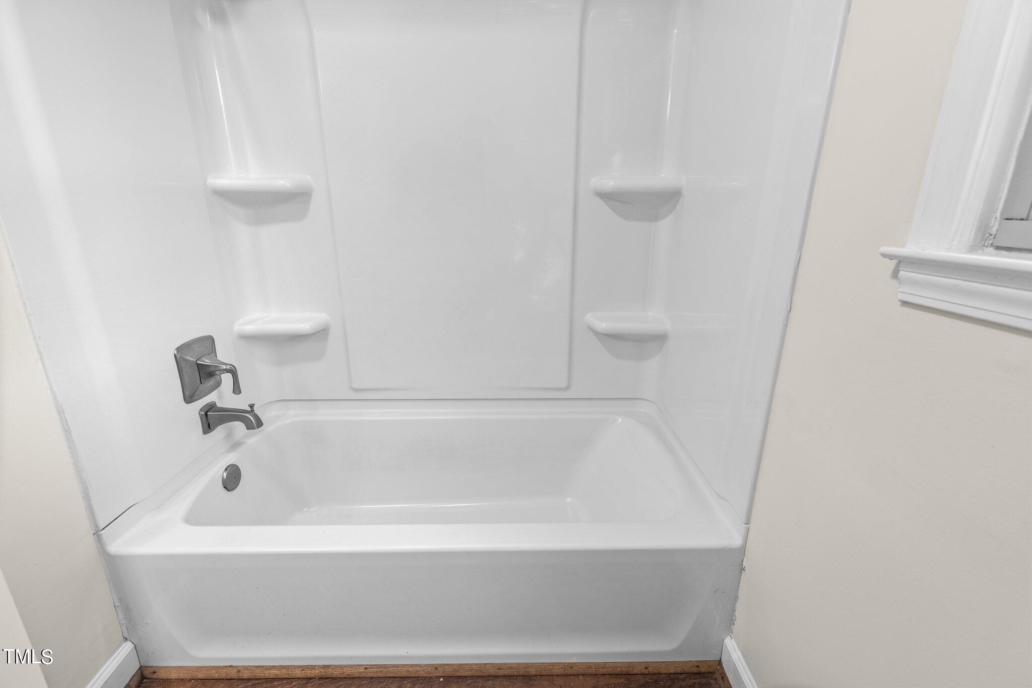 1207 Dover Street Roxboro, NC 27573 - Photo 17 of 31 a white bath tub sitting next to a white sink