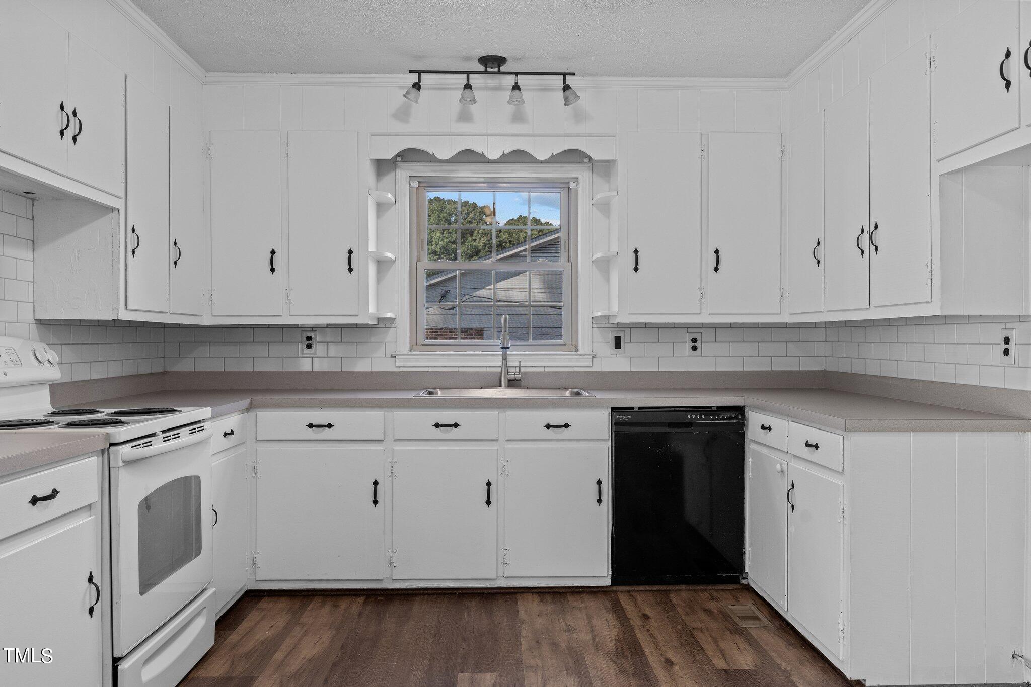 1207 Dover Street Roxboro, NC 27573 - Photo 5 of 31 a kitchen with granite countertop white cabinets and white appliances