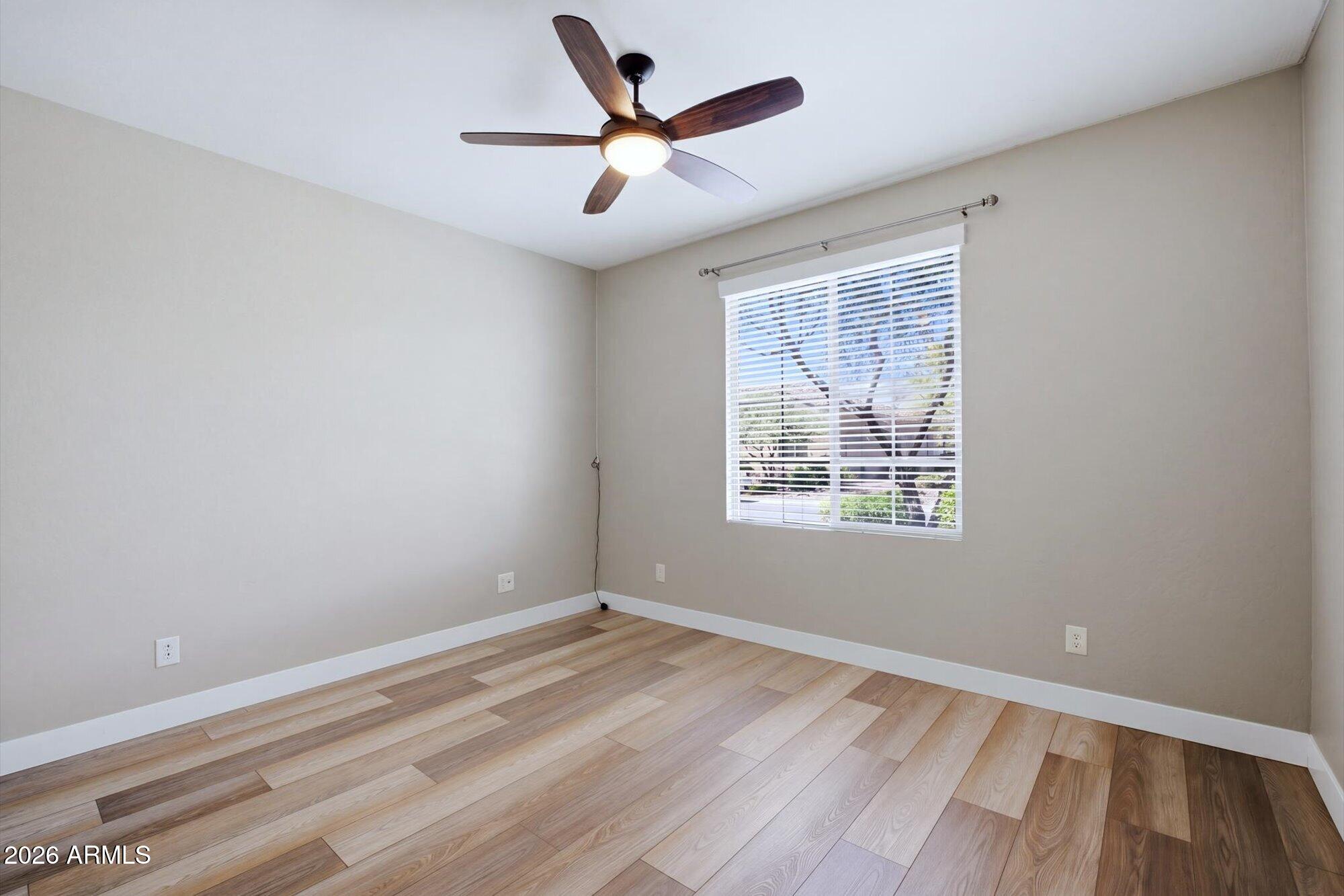 16849 West Merrell Street Goodyear, AZ 85395 - Photo 22 of 35 wooden floor in an empty room with a window