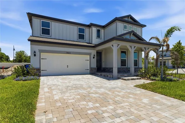 a front view of a house with a yard and garage