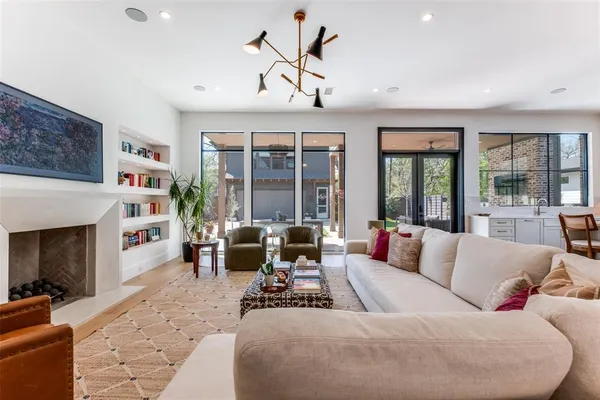 a living room with furniture large window and fireplace