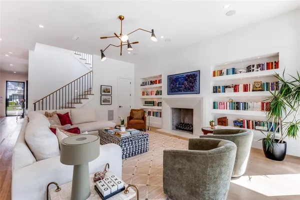 a living room with furniture fireplace and book shelf