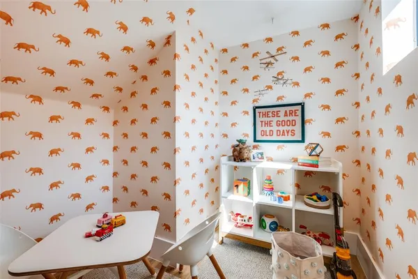 a room with a small workspace and a lamp