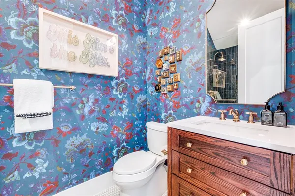 a bathroom with a toilet sink and mirror