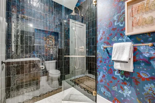 a bathroom with a sink toilet and shower