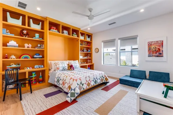 a bedroom with a bed and a bookshelf