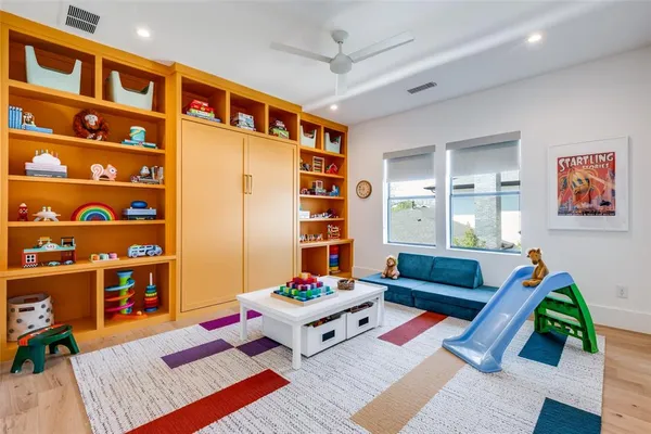 a living room with furniture and bookshelf