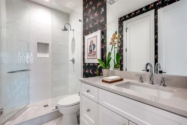 a bathroom with a granite countertop sink toilet and shower