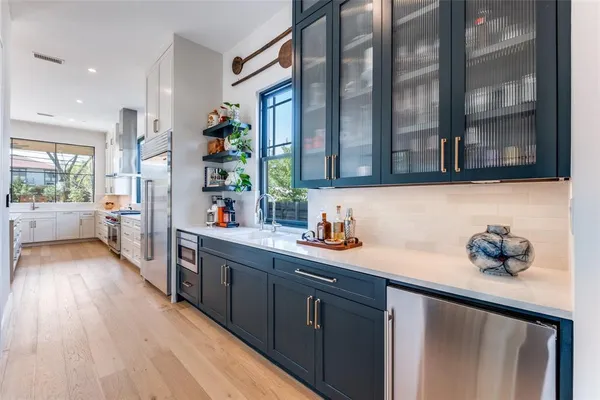 a kitchen with a sink cabinets and wooden floor