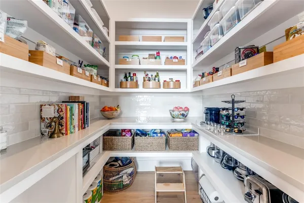 a utility room with stainless steel appliances cabinets and a table