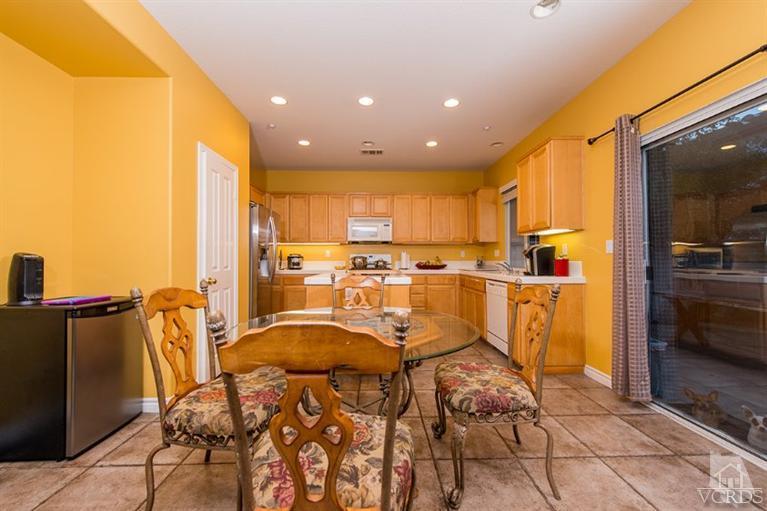 1892 Ribera Drive Oxnard, CA 93030 - Photo 13 of 34 a view of a kitchen with kitchen island stainless steel appliances refrigerator stove microwave and cabinets