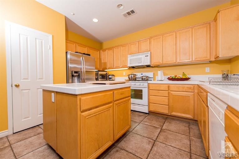 1892 Ribera Drive Oxnard, CA 93030 - Photo 14 of 34 a kitchen with stainless steel appliances granite countertop a stove sink and cabinets