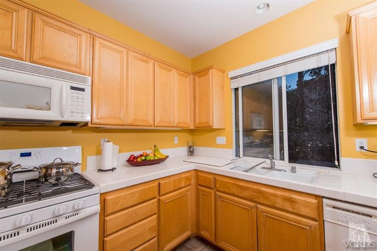 1892 Ribera Drive Oxnard, CA 93030 - Photo 15 of 34 a kitchen with stainless steel appliances granite countertop a sink and cabinets