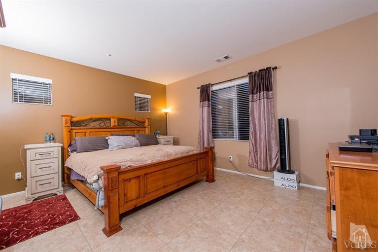 1892 Ribera Drive Oxnard, CA 93030 - Photo 27 of 34 a bedroom with a bed and a dresser with mirror