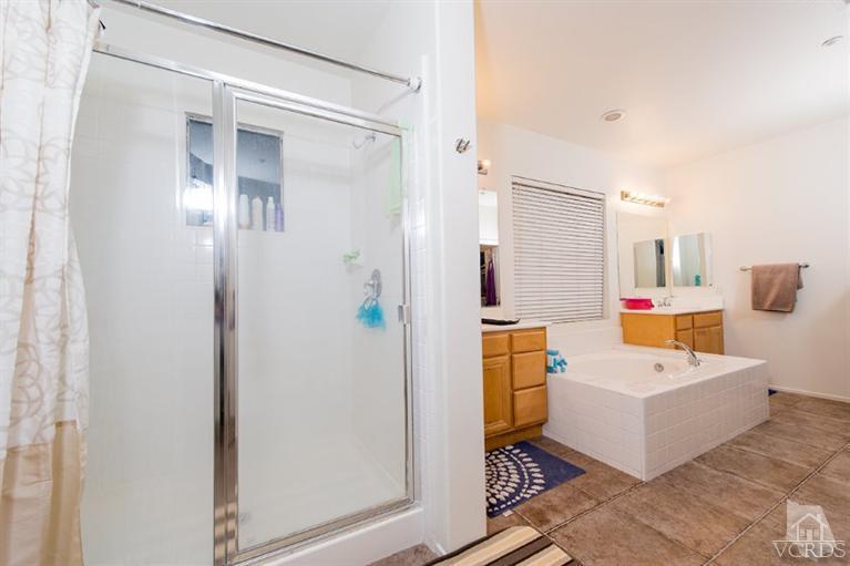 1892 Ribera Drive Oxnard, CA 93030 - Photo 31 of 34 a bathroom with a sink a mirror and shower